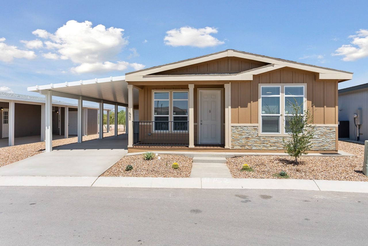 Brand-new manufactured home for sale with covered carport and landscaped yard in a CRI community